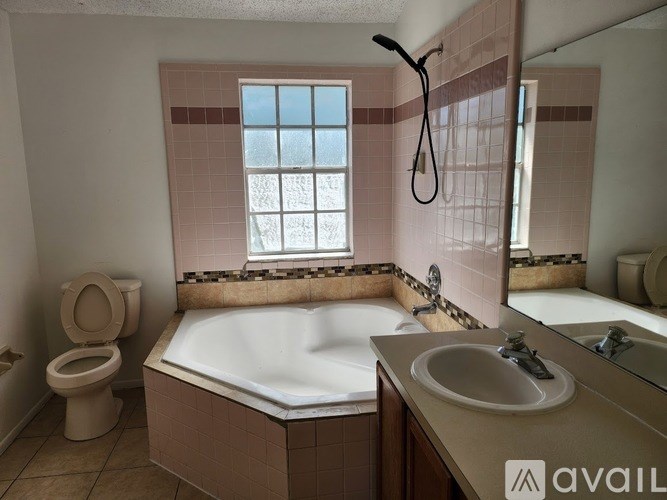 A bathroom with a toilet, sink, and bathtub.