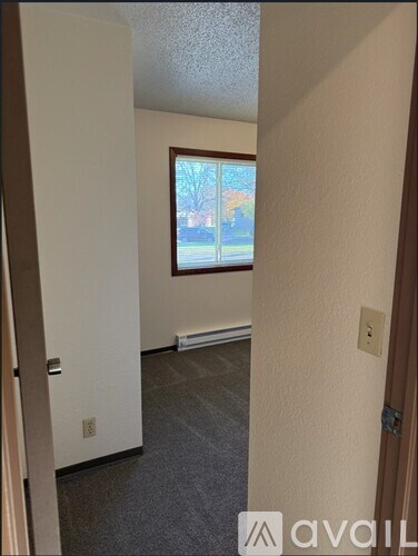 A room with a window and a door.