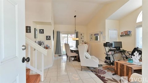 A living room with a white chair and a brown coffee table.
