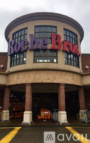 A Roche Bros storefront with a yellow line in front.
