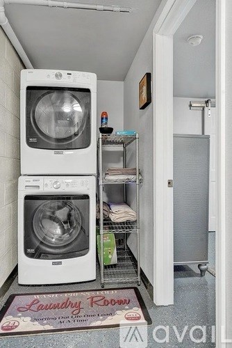 A laundry room with a washer and dryer stacked on top of each other.