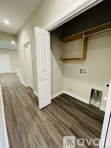 A hallway with wood floors and white doors.