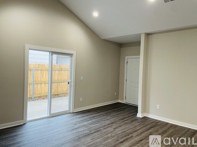 A room with a sliding glass door leading to a backyard.