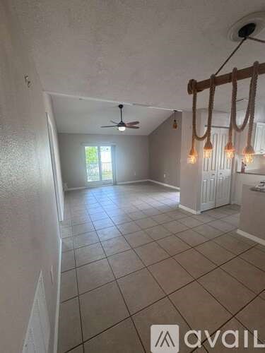 A room with a ceiling fan and a window.