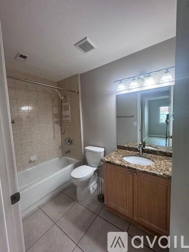 A bathroom with a toilet, sink, and bathtub.