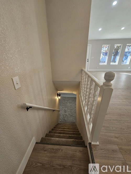 A staircase with a light on the side.