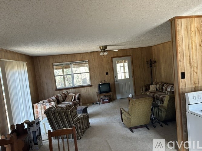 A living room with striped couches and a television.