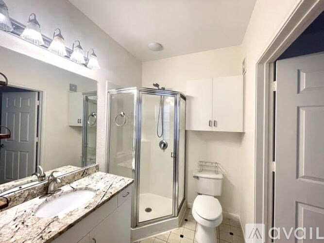 A bathroom with a sink, toilet, and shower.
