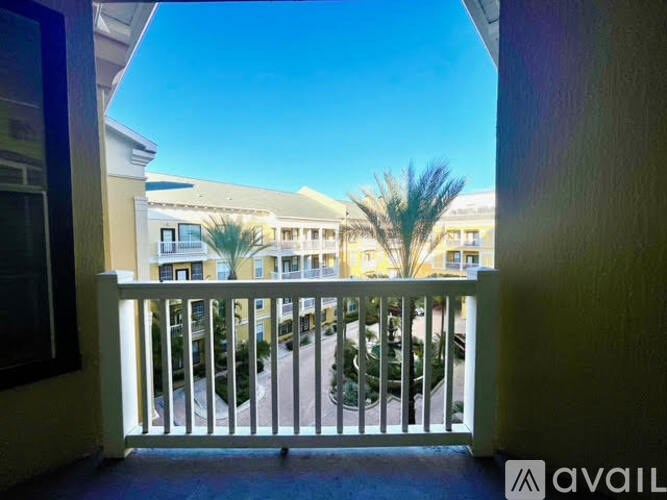 A balcony view of a building with a clear blue sky.