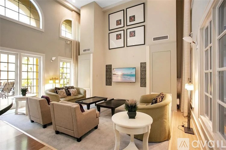 A living room with a couch, chairs, and a coffee table.