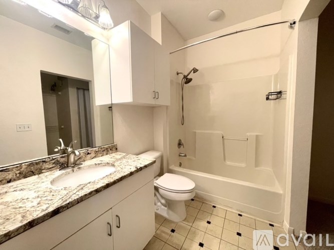 A bathroom with a sink, toilet, and bathtub.