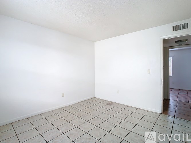 Empty room with tiled floor and white walls.