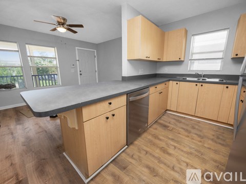 A kitchen with wooden cabinets and a grey countertop.