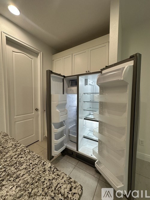 A refrigerator with its door open in a kitchen.