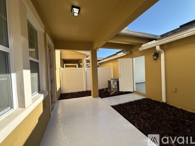 A sunny day at the beach with a yellow building in the foreground.