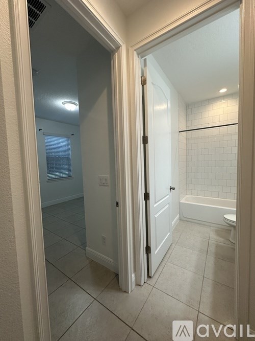 A bathroom with a toilet, sink and bathtub.