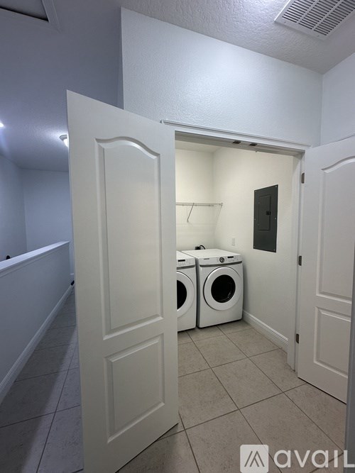 A laundry room with a washer and dryer in it.