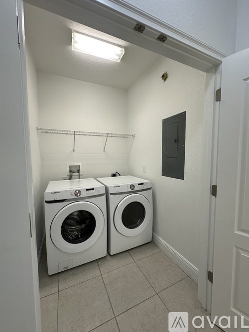 A small laundry room with two front loading washing machines.
