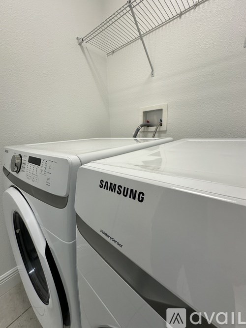 A Samsung washing machine and dryer in a laundry room.