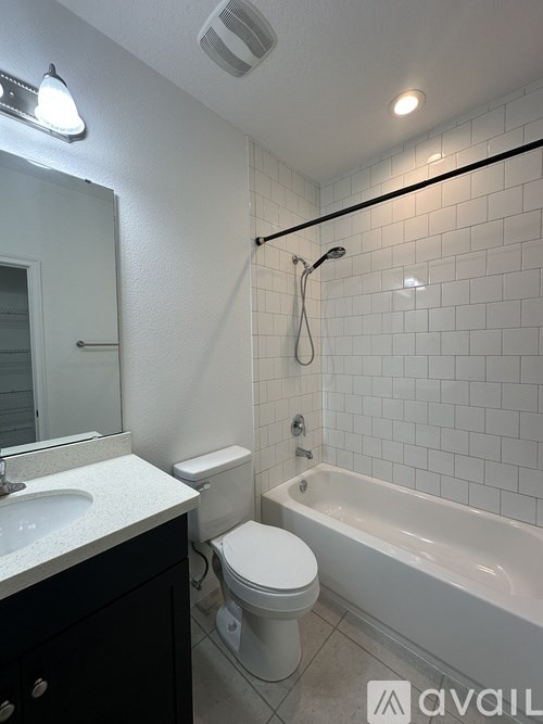 A white toilet is next to a white sink in a bathroom.