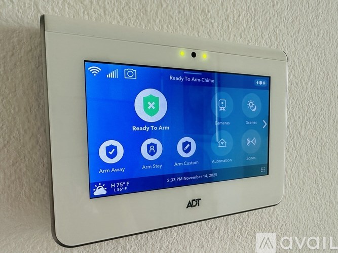 A white ADT security system display shows the status as "Ready To Arm" with various options like Arm Away, Arm Stay, Arm Custom, and Automation.