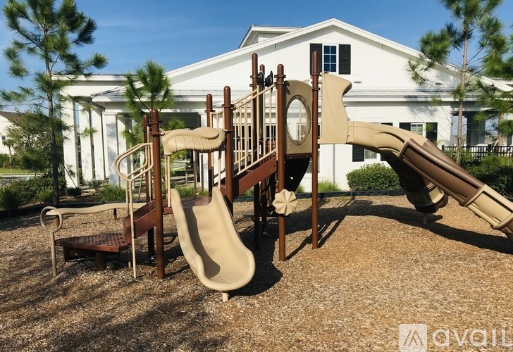 A playground with a slide, swings, and a climbing frame.