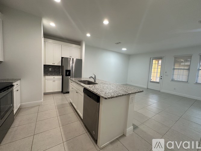 A kitchen with granite countertops and stainless steel appliances.