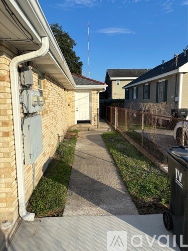 A residential area with a sidewalk and houses.
