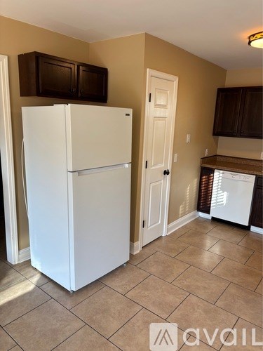 A white refrigerator in a kitchen with a white door and a white interior.