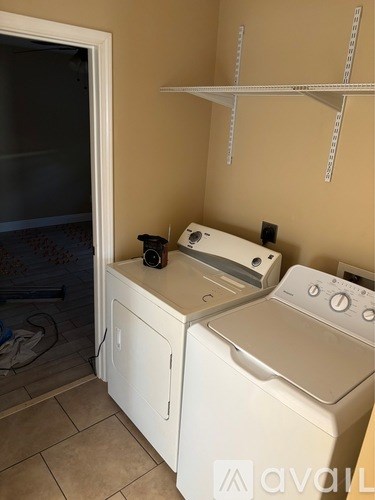 A small laundry room with a washer and dryer.