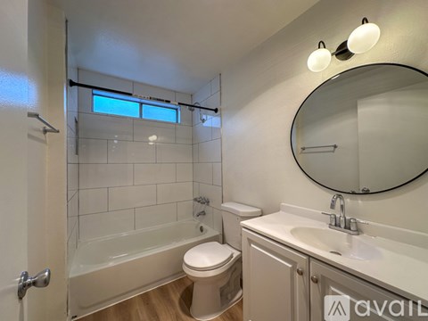 A bathroom with a toilet, sink, and shower.