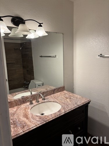 A bathroom with a sink and mirror.