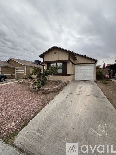 A house with a driveway and a car parked in front.