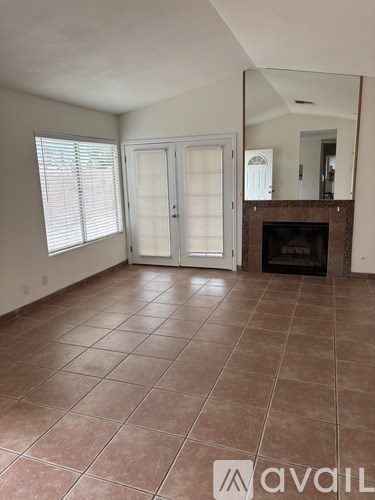 A room with a tiled floor and a fireplace.