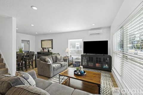 A living room with a grey couch and a coffee table.