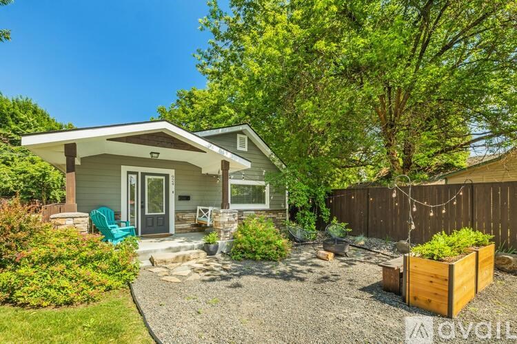 A house with a gravel driveway and a green chair.