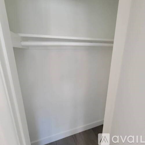 A white shelf with a grey floor.