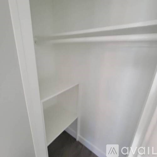 A white shelf with a cut off corner.