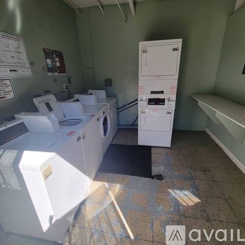 A room with washing machines and a sign on the wall.