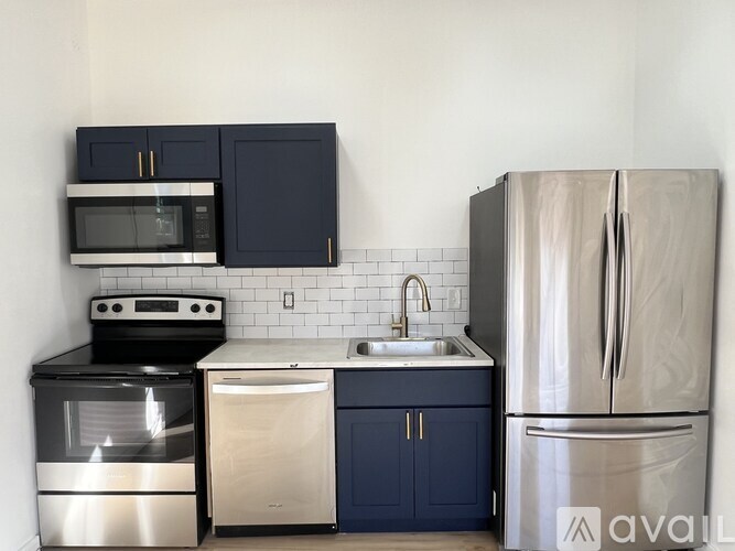 A kitchen with a stainless steel refrigerator, dishwasher, oven, and microwave.