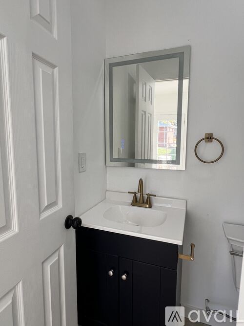 A bathroom with a sink, mirror, and toilet.