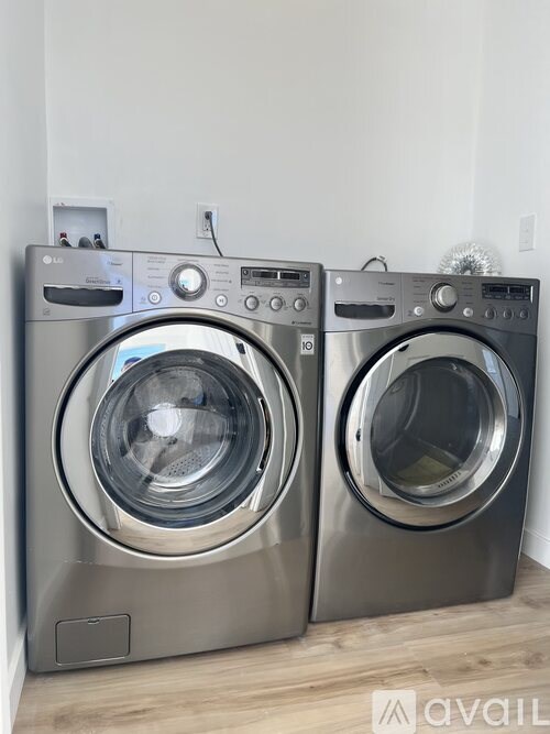Two front load washing machines in a laundry room.