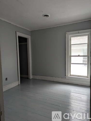 A room with a window and a door.