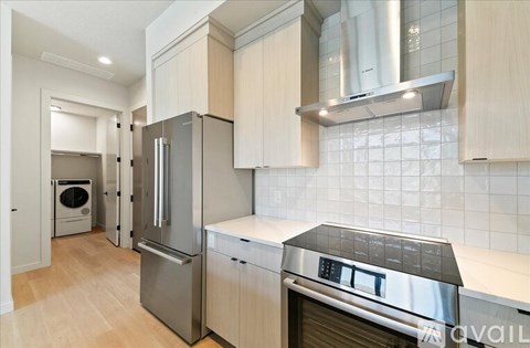 A kitchen with a stainless steel refrigerator and oven.