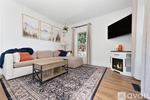A living room with a white couch and a coffee table.