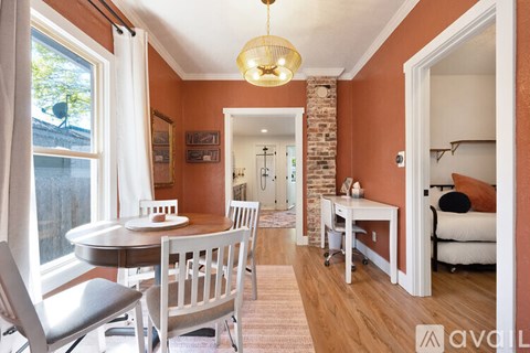 A dining room with a table and chairs.