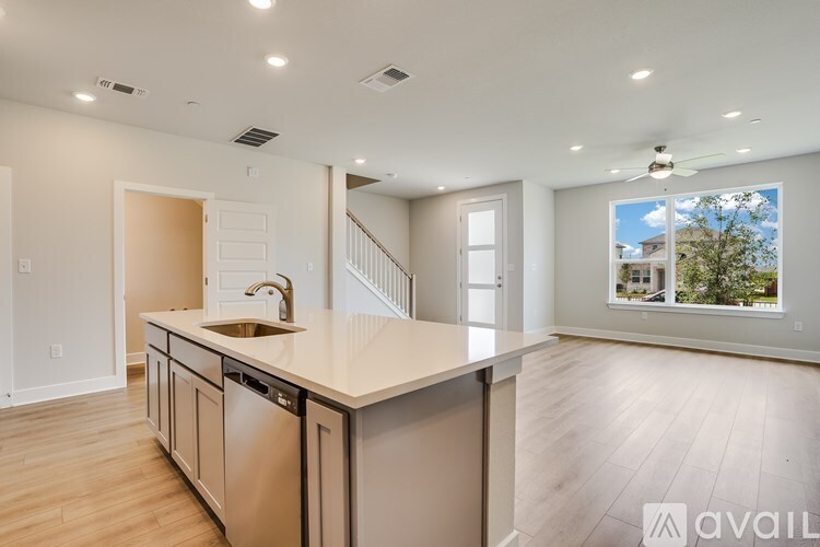 A modern kitchen with a large island and stainless steel appliances.