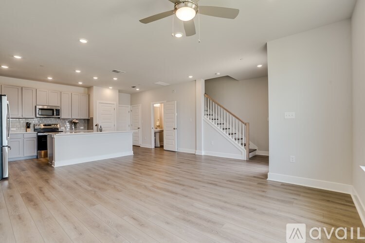 A spacious kitchen with a refrigerator, microwave, and oven.