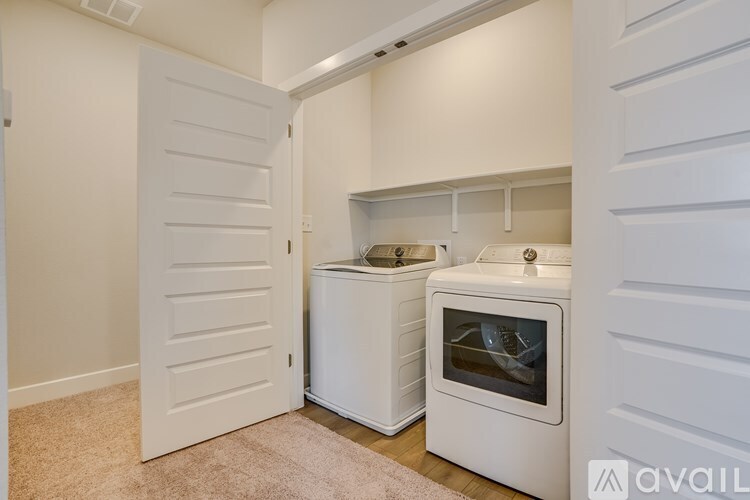 A white kitchen with a white oven and white cabinets.