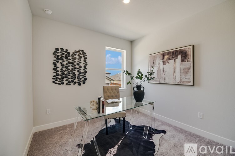 A living room with a glass table and a black cowhide rug.